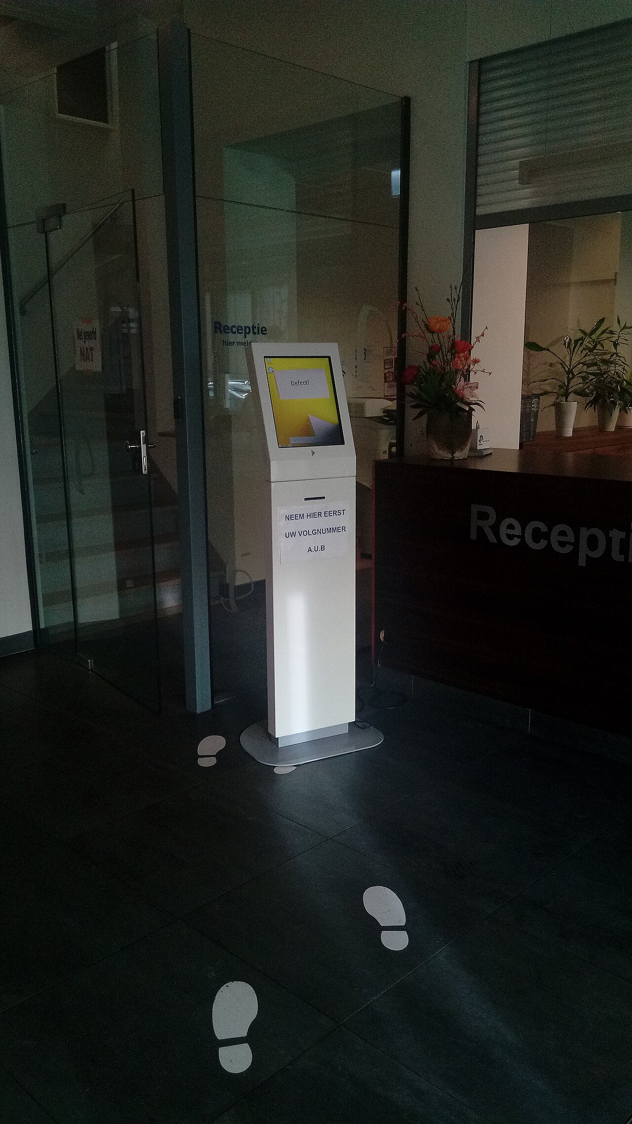 Reception area of the editorial office with a directory board
